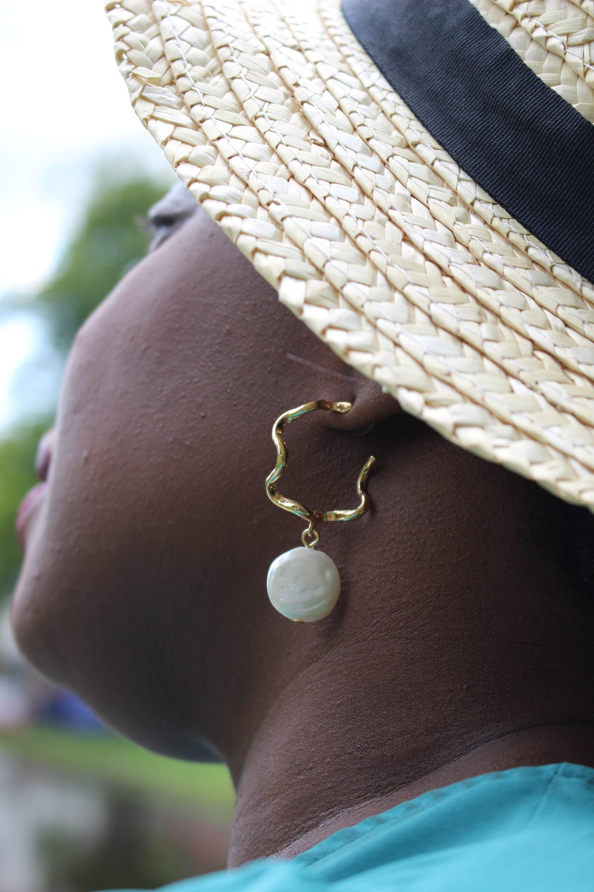 dark skinned lady wearing Giana Natural Pearl drop loop earrings