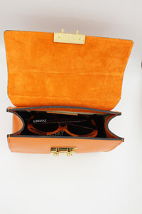 Orange Kelly Bovine Leather bag with interior orange kid-suede material and Tonbey Cat-eye glasses
