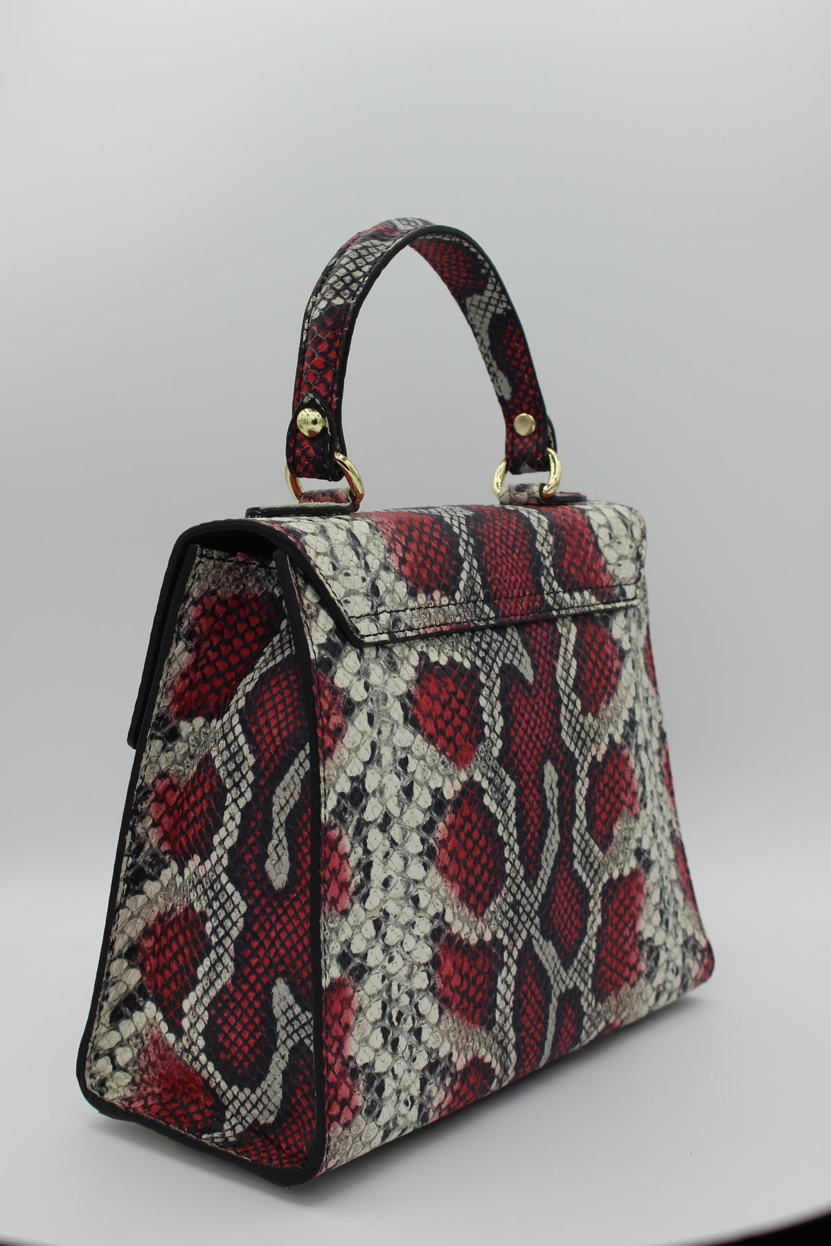 Red snake embossed leather bag slanted view